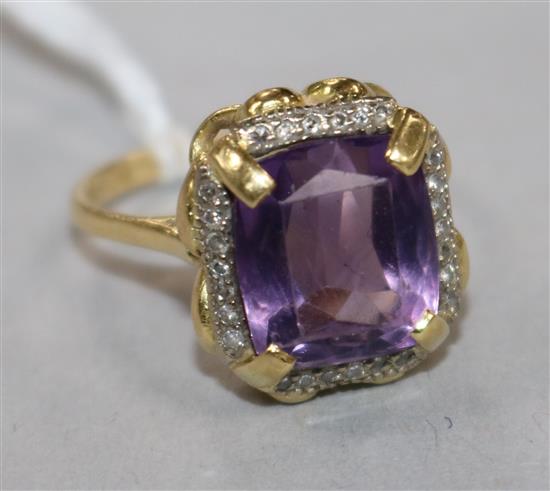 An 18ct gold, amethyst and diamond set dress ring, size M.